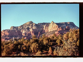 Panoramic view of landscape against clear blue sky