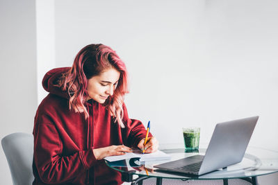 Young woman using laptop at home