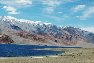 Scenic view of lake against cloudy sky