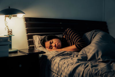 Young woman sleeping in bed