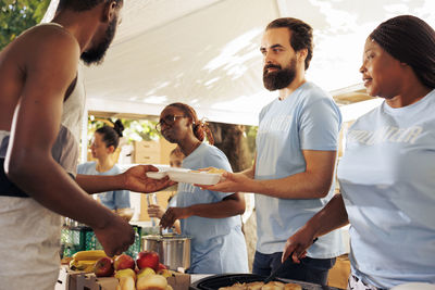 Rear view of family having food at home