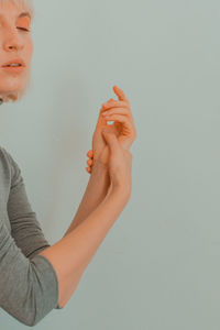 Close-up of woman hands against white background