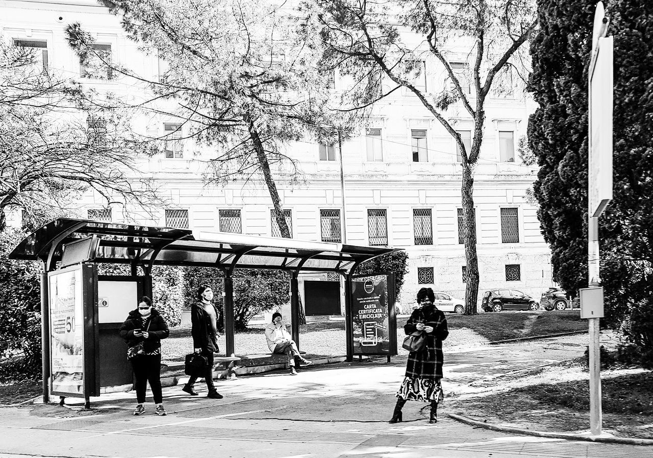 PEOPLE ON STREET AGAINST BUILDINGS