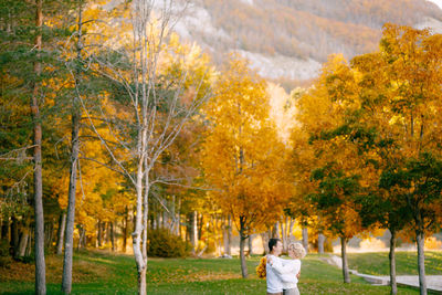 Rear view of woman standing in park