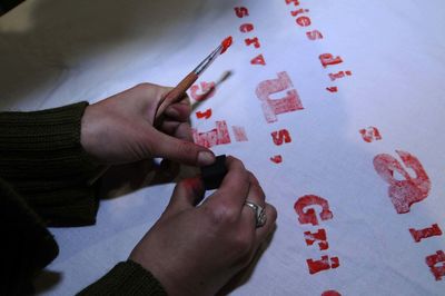 Cropped hand of woman writing on paper