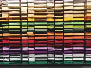 Colorful papers stacked on rack