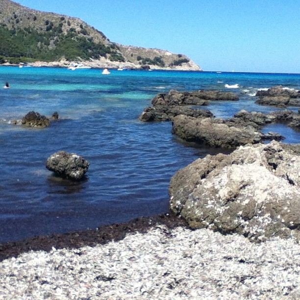 sea, water, scenics, rock - object, tranquil scene, blue, clear sky, tranquility, beauty in nature, horizon over water, rock formation, beach, nature, rock, shore, idyllic, mountain, day, sky, outdoors