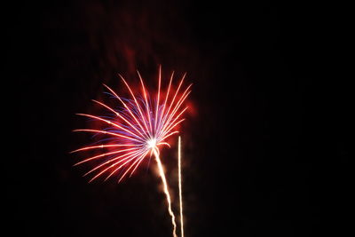 Low angle view of firework display at night