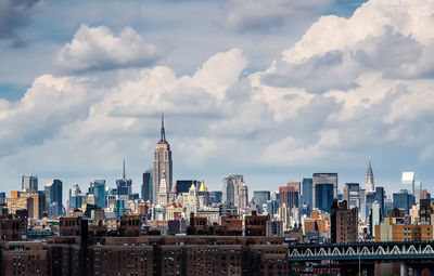 Skyscrapers against cloudy sky