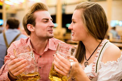 Young couple having beer at restaurant