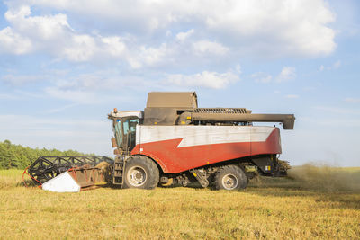 Tractor on field against sky