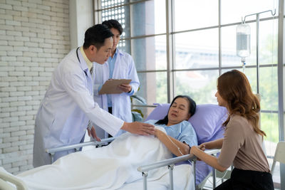 Side view of doctor examining patient in office