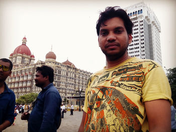 Portrait of young man in city