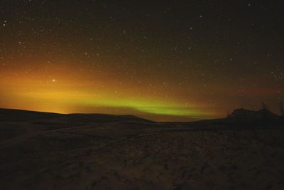 Scenic view of landscape against sky at night