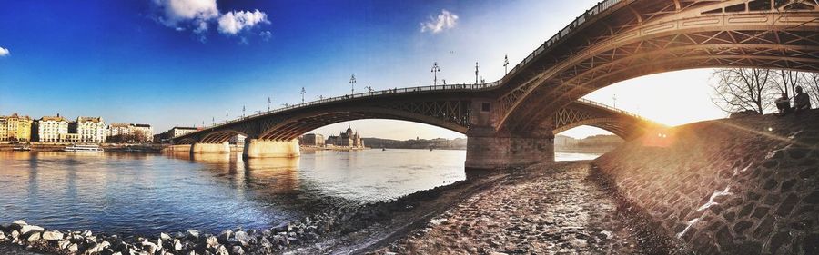 Panoramic view of bridge over river against sky during sunset