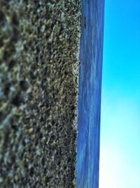 Surface level of sea against clear blue sky