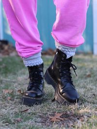 Women in pink joggers, slouchy socks and dr martens jadon workboots.