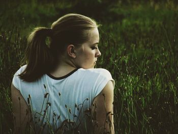 Portrait of woman standing on grassy field