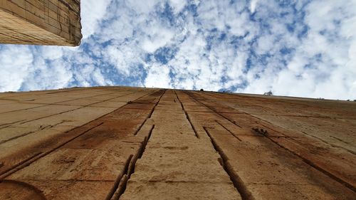 Low angle view of building against cloudy sky