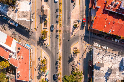 Aerial view of the street intersection with cars driving down the road.