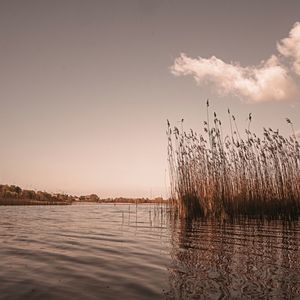 Scenic view of lake against sky during sunset