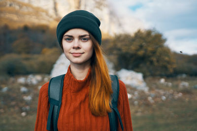 Portrait of smiling young woman standing outdoors