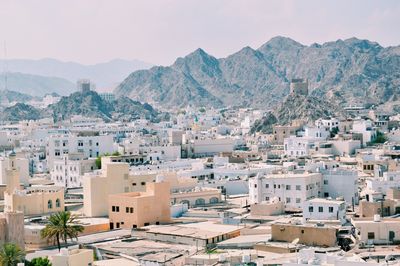 Houses in city against sky