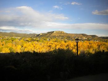 Scenic view of field against cloudy sky