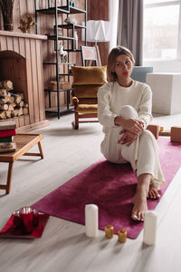 Portrait of woman sitting on table at home