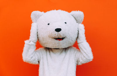 Close-up of stuffed toy against orange background