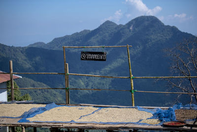 Information sign on mountain against blue sky
