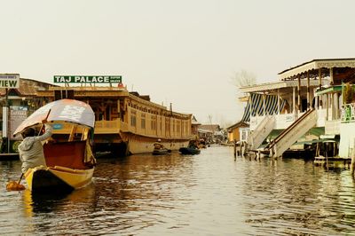 Boats in river with buildings in background