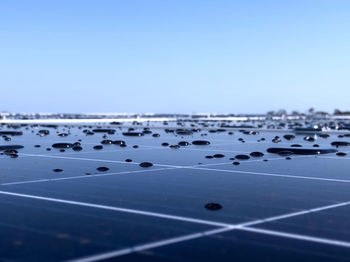 Rain drops on solar panels, working on a solar farm 