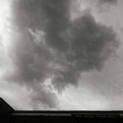 Low angle view of building against cloudy sky
