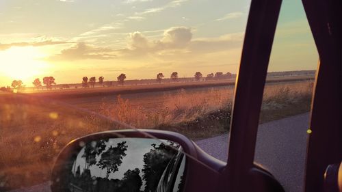 Cropped image of car on road against sky