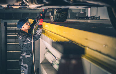 Close-up of mechanic working at garage