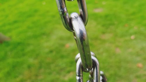 Close-up of chain hanging on rope