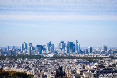 Aerial view of buildings in city against sky