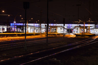 Train on railroad station platform at night