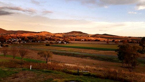 Scenic view of field against sky during sunset