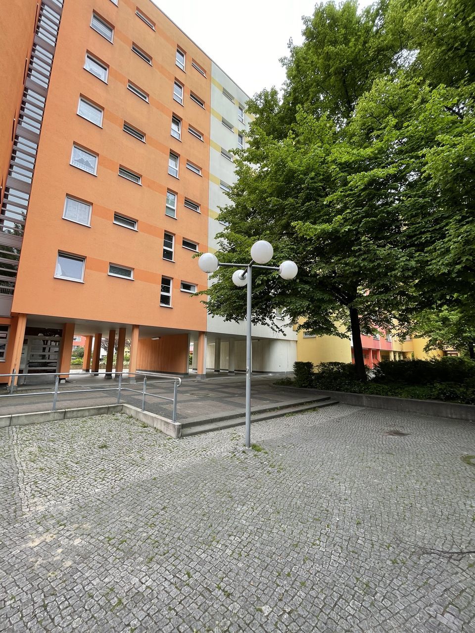 STREET BY BUILDINGS AGAINST SKY