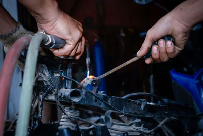 Cropped hands of man working in workshop