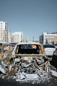 Vertical photo of destroyed engine and under the hood space of burned car. arson of a vehicle.