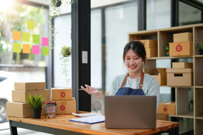 Businesswoman using laptop at table