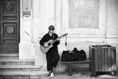 Full length of man playing guitar