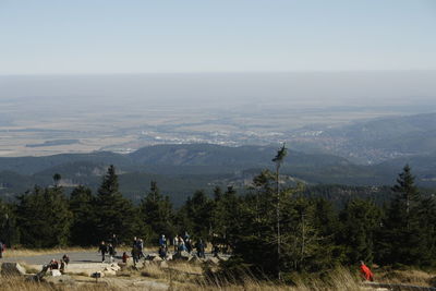 People on mountain against clear sky