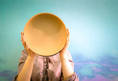 Master potter holds round clay plate in his hands.potter's body. sculptor sculpts pots  