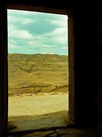 Scenic view of field against sky seen through window