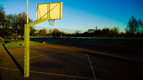 Empty playground against clear blue sky