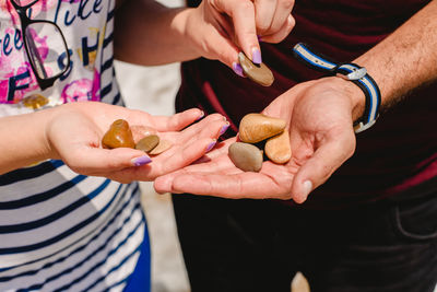 Midsection of people holding ice cream